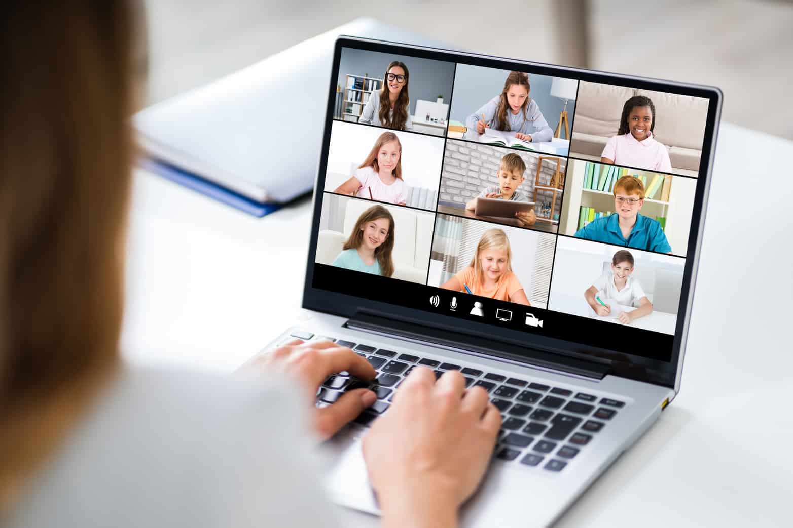 Teacher Hosting Online Class Using Video Conference On Laptop