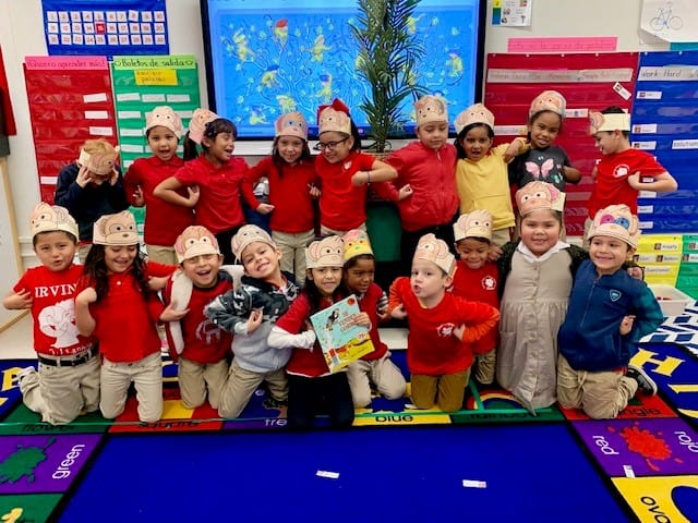 Kindergarten class wearing funny hats after reading lesson