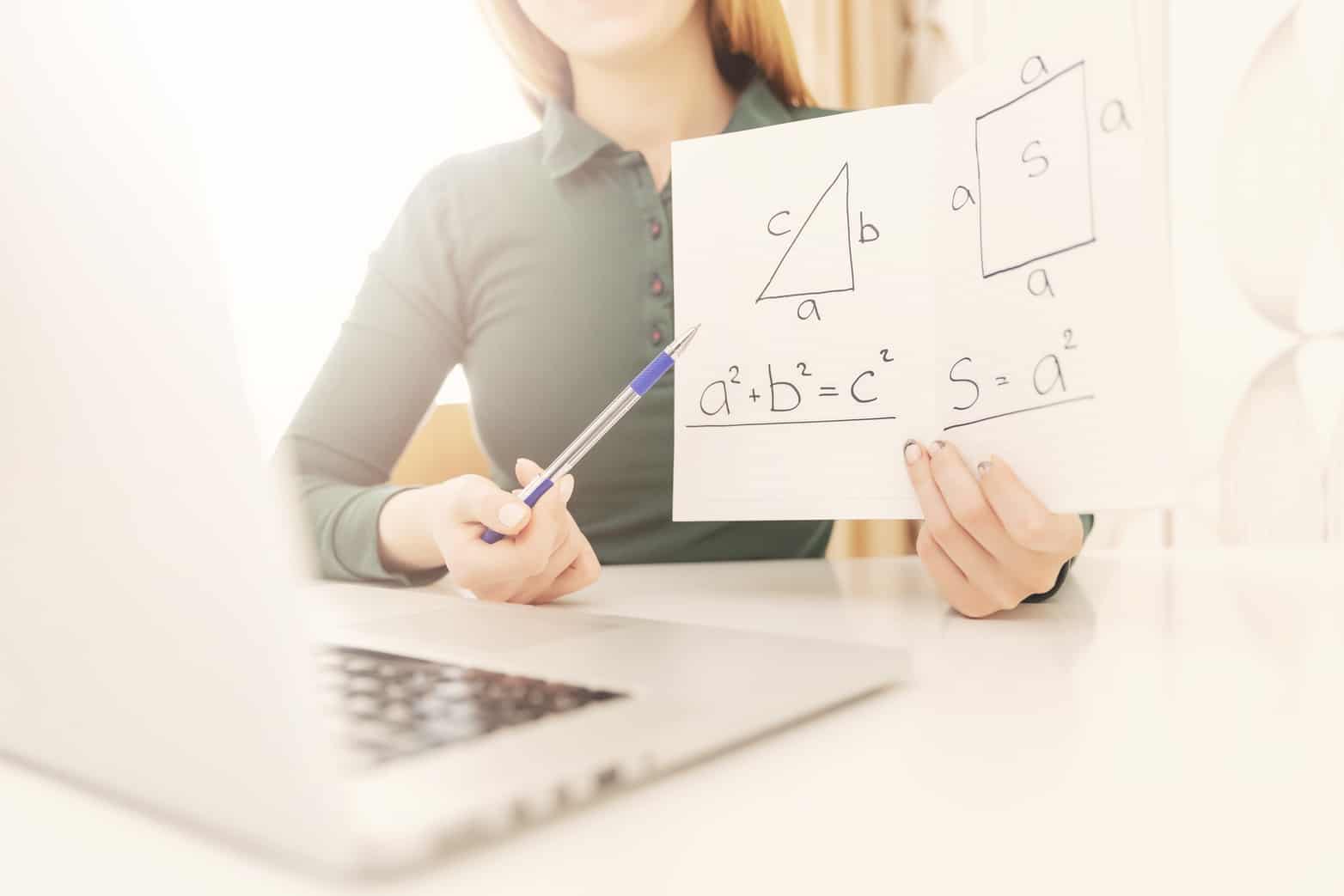 Math teacher explains online lesson to students